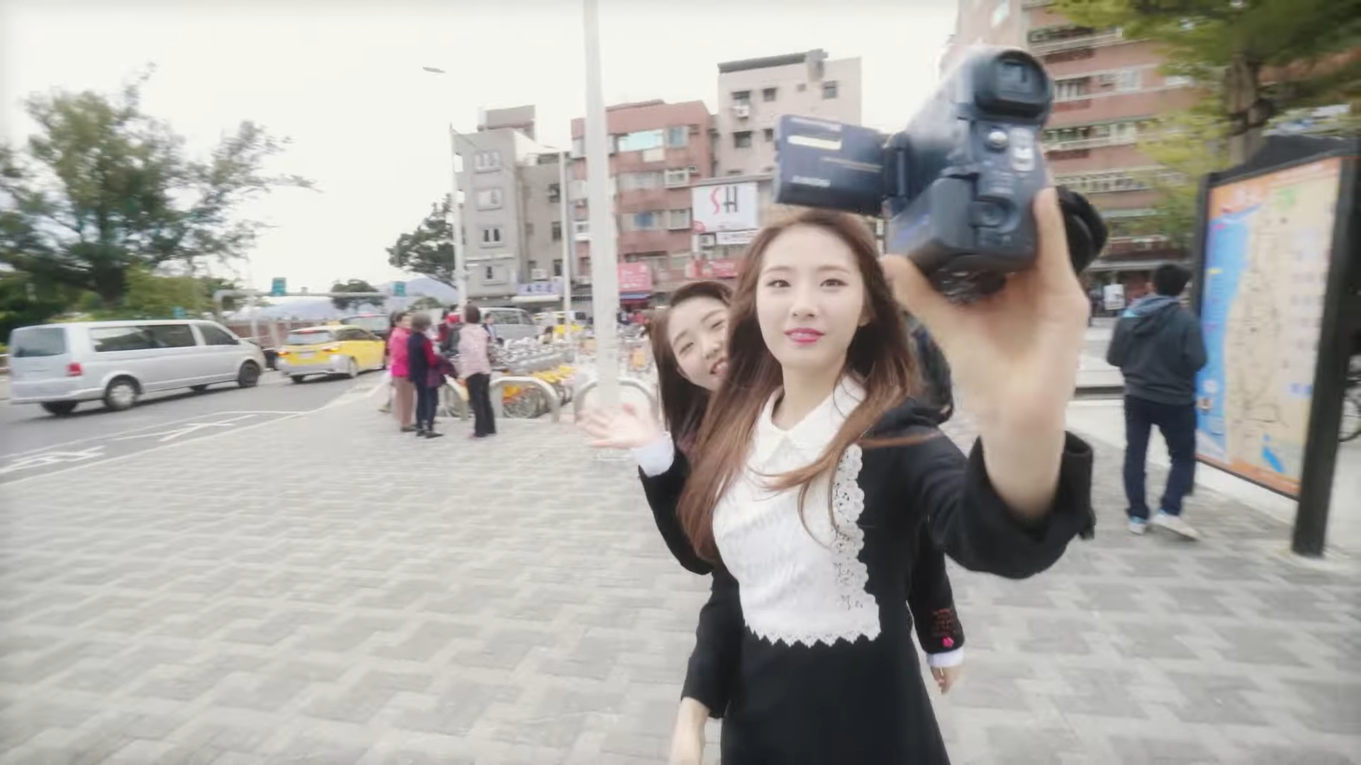 Haseul filming with a camcorder.